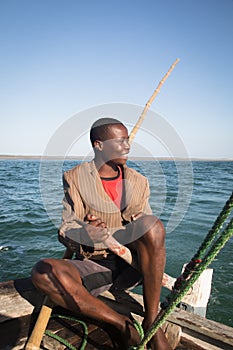 African man stearing a boat near Tofo